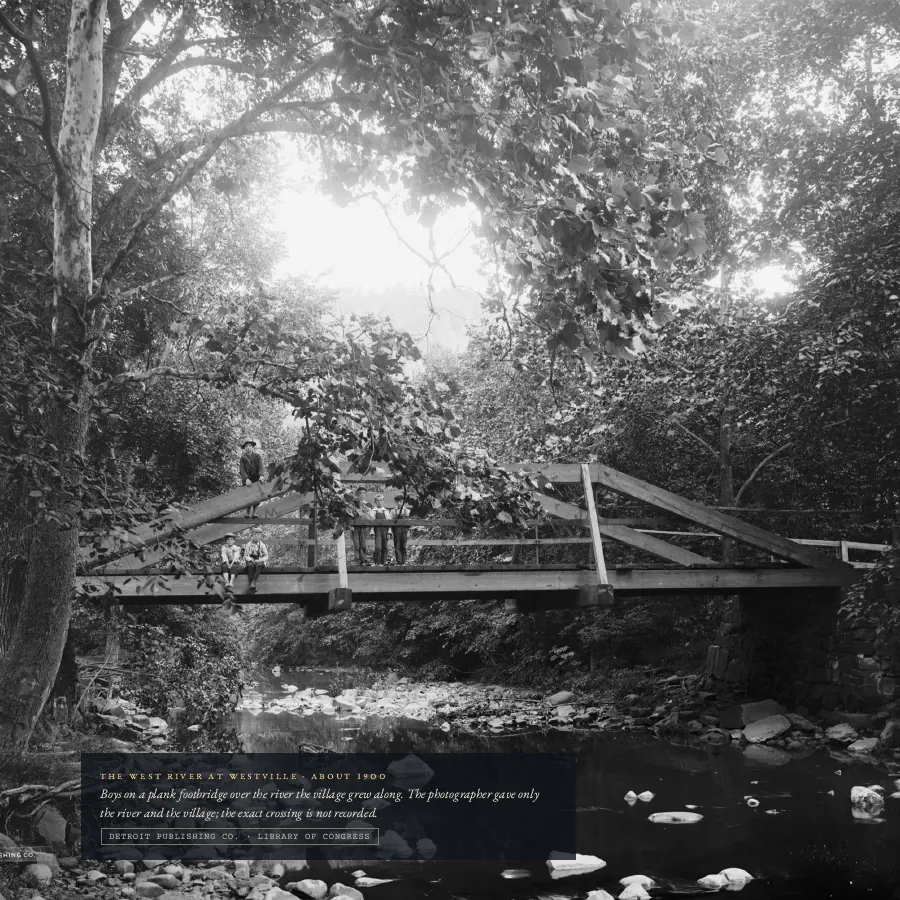 A full-page photograph of a footbridge over the West River, about 1900.
